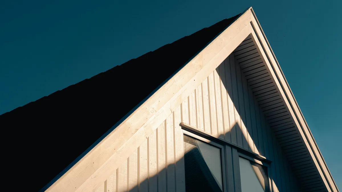 A-frame residential home at golden hour in Utah County — exterior siding and roofing