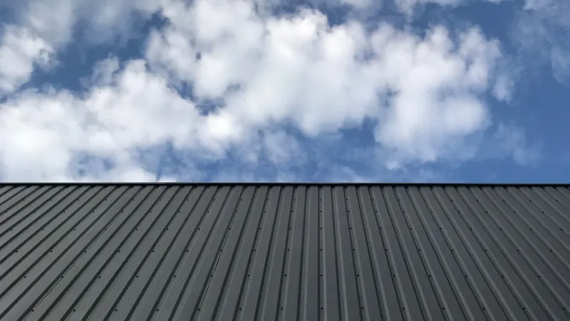 Standing seam metal panels against Utah sky — Rhino Roofing and Exteriors installation