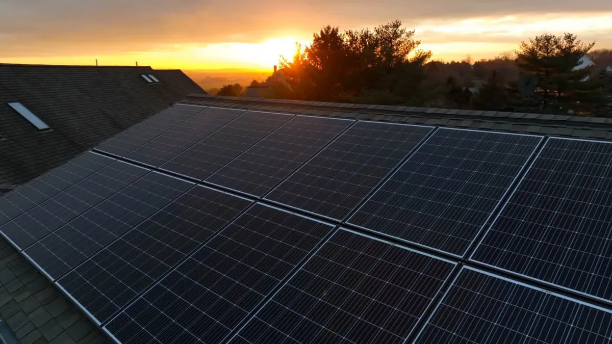 Solar panel mounting detail at sunset — close-up of panel attachment hardware on Utah residential roof